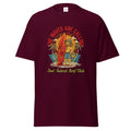 Dark navy cotton T-shirt featuring a vibrant graphic of a dog with a surfboard, tropical background, and 'The Waves Are Calling' text
